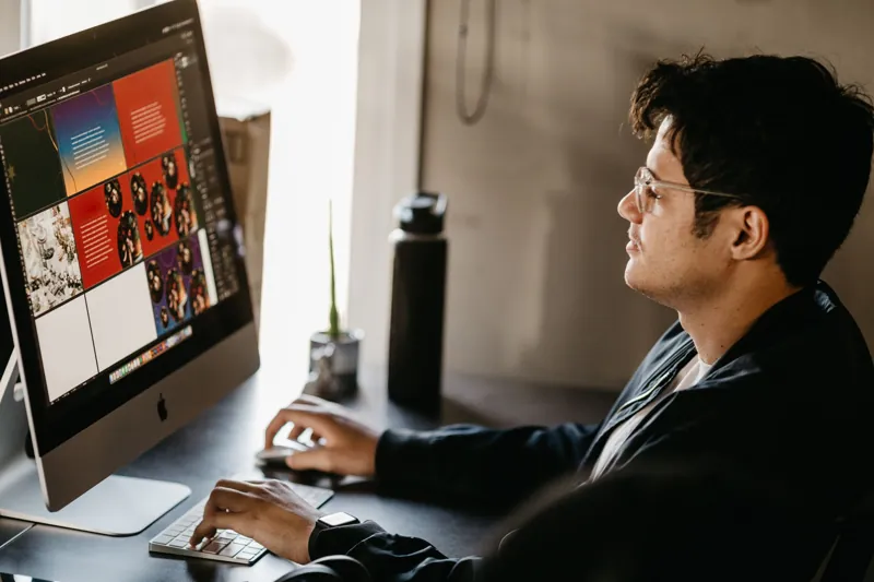 Designer working on a website layout on a large screen
